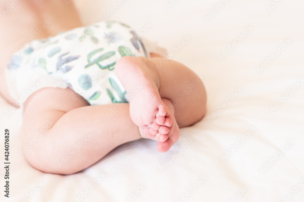Newborn baby feet on white blanket, happy family concept Newborn baby feet on white blanket, happy family concept