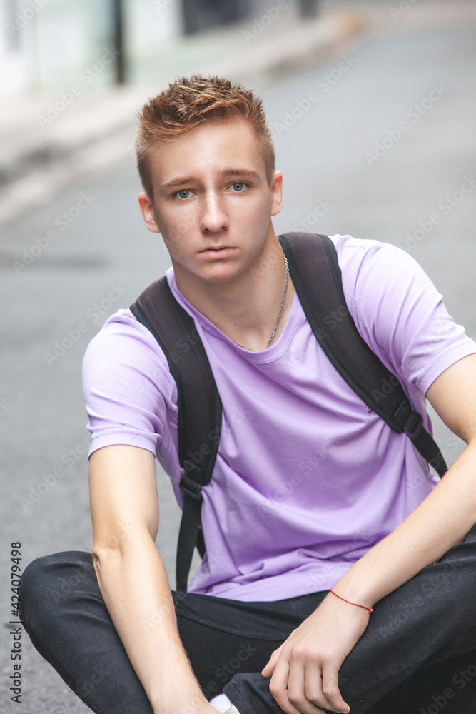 Young guy sitting on the street Young guy sitting on the street