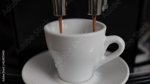 Coffee machine in detail - Espresso flows into a cup - studio photography