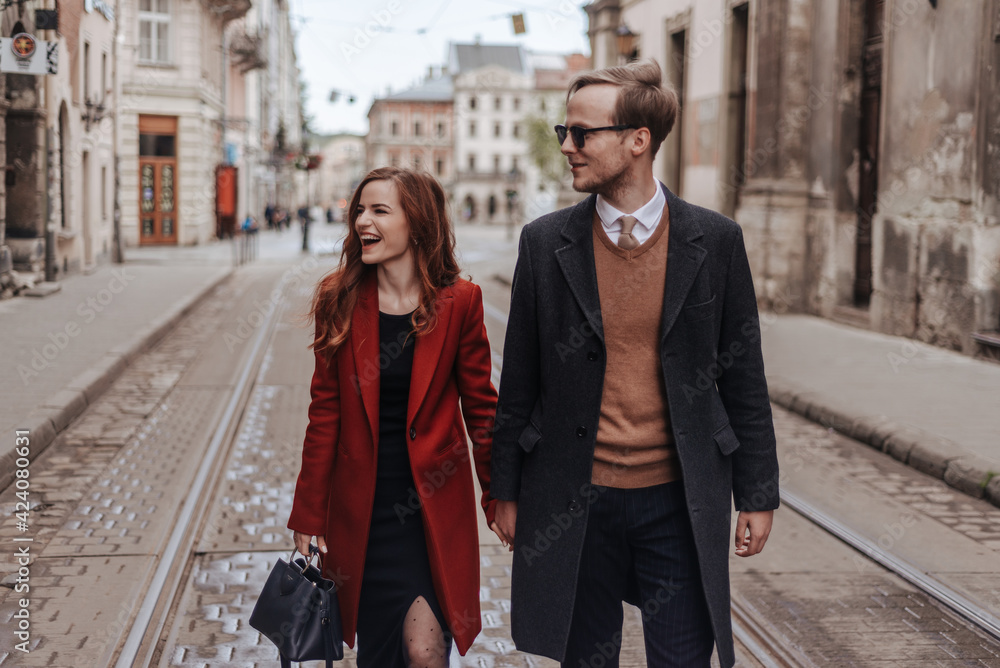 Stylish couple walking on date at springtime outdoor Stylish couple walking on date at springtime outdoor