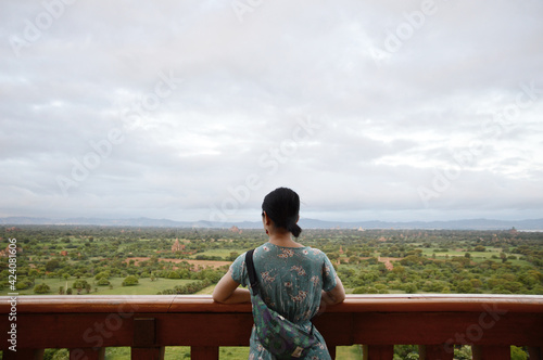 Young girl standing on the balcony of the Bagan View Point to have great view of the World Heritage Site 