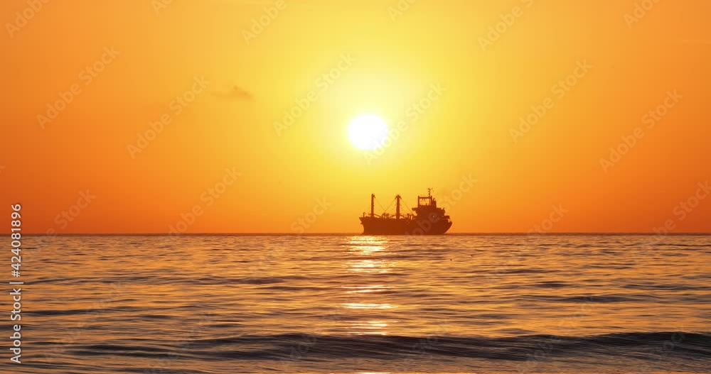 Sailing cargo ship and flying birds during beautiful sea sunrise, 4k video Sailing cargo ship and flying birds during beautiful sea sunrise, 4k video