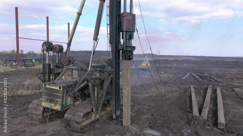 Excavation at a construction site, diesel pile driving machine with ...