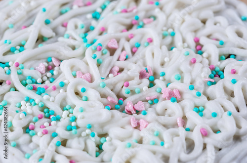 The texture of icing on a cake with pastry sprinkles, macro photography