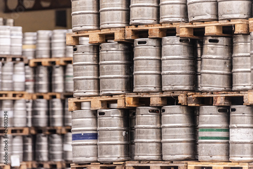 Beer barrels. Beer factory. Beer warehouse. Racks of beer barrels on pallets.
