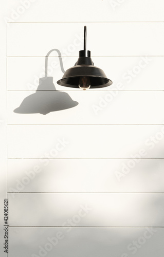 black Hanging lamp decorate exterior with shadows on white wall and copy space