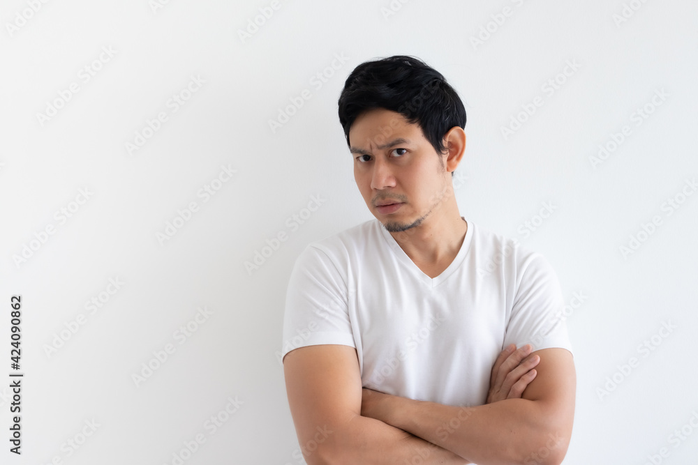 Obraz premium Serious and upset Asian man wears white t-shirt isolated on white background.