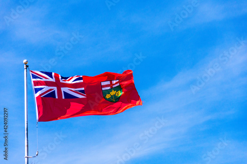 Photography The flag of the province of Ontario, Canada waves in the breeze against a blue sky