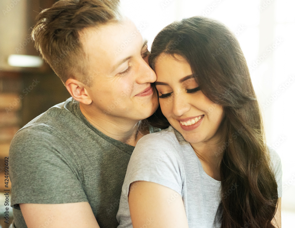 Lifestyle, family and young people concept: lovely couple in love hugging on the kitchen Lifestyle, family and young people concept: lovely couple in love hugging on the kitchen