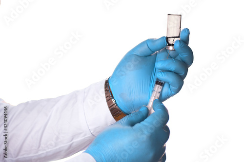 hand holding syringe and glass of liquid vaccine or drug