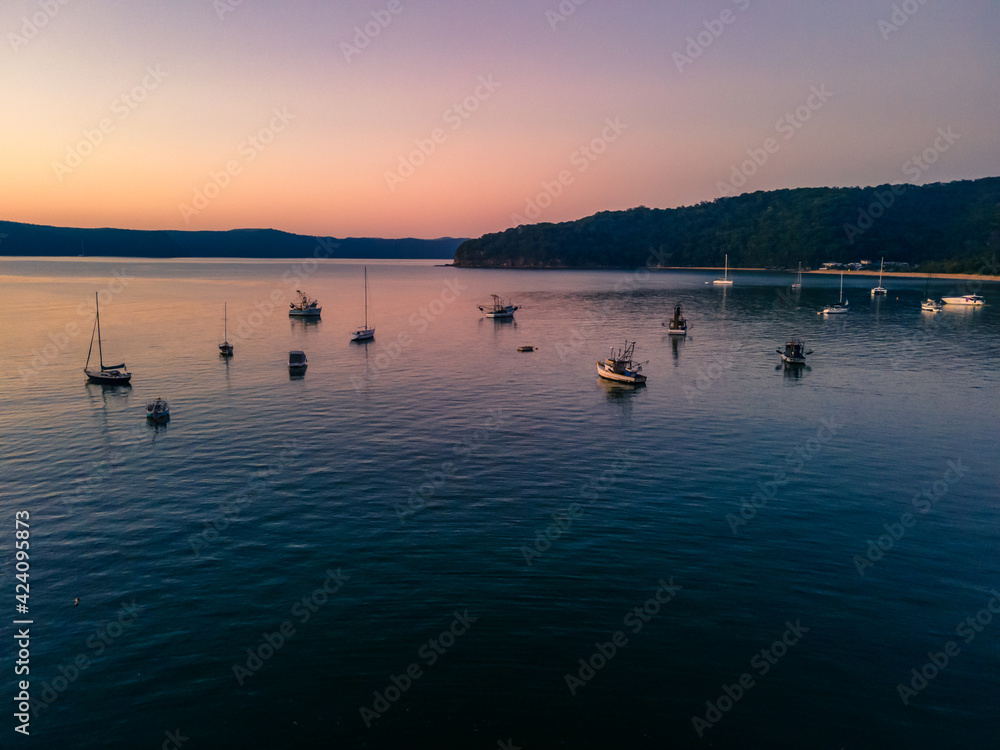 Boats at rest and gentle sunrise over the bay Boats at rest and gentle sunrise over the bay