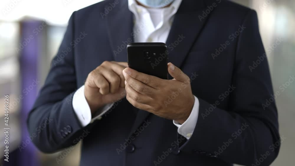 Close up male hand using smartphone and travel by sky train in train station. Close up male hand using smartphone and travel by sky train in train station.