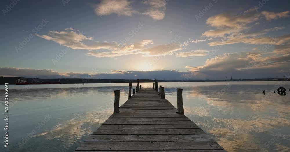 Old wooden dock at the lake, colorful sunset clouds, 4k video Old wooden dock at the lake, colorful sunset clouds, 4k video