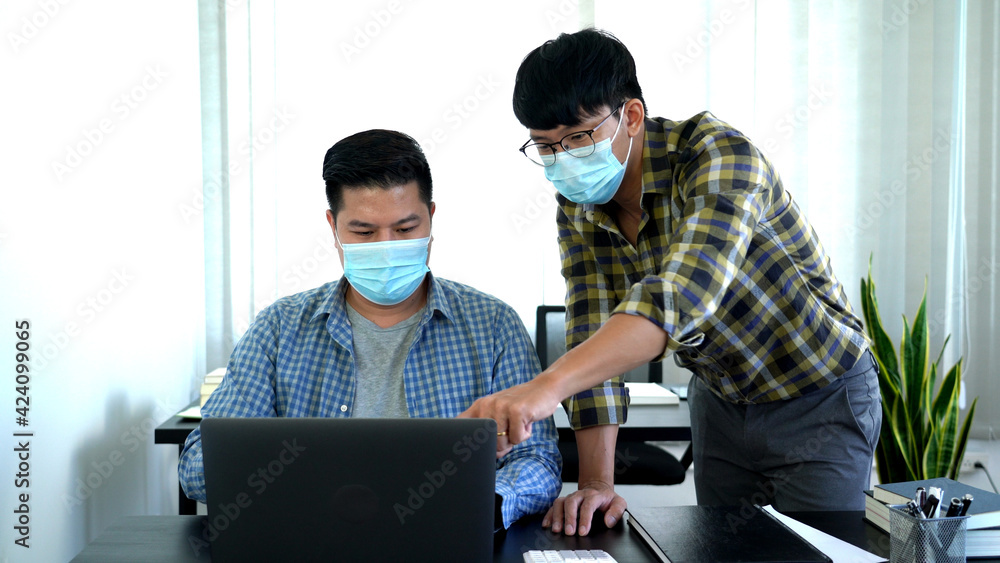 new normal business practise business people have a meeting worker wearing face protective mask at coworking space, Health and teamwork concept. new normal business practise business people have a meeting worker wearing face protective mask at coworking space, Health and teamwork concept.