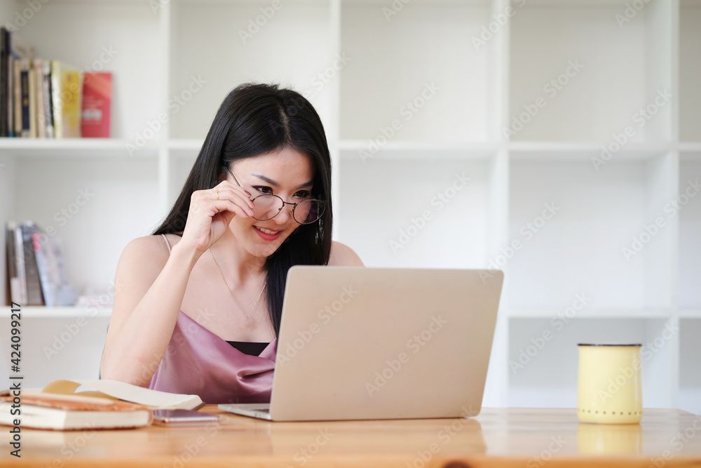 A young female administrative assistant making notes of working planning organizing information in her office. A young female administrative assistant making notes of working planning organizing information in her office.
