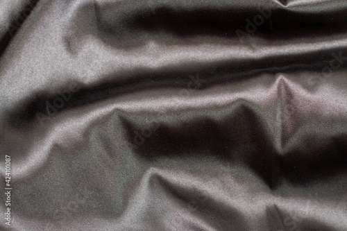 Gray elegant Silk fabric with a large fold and draped waves.