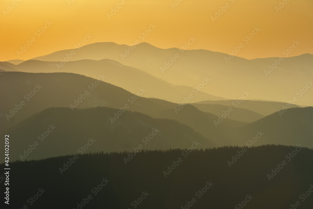 Beautiful sunrise in the Carpathian mountains with fog and dramatic sky	