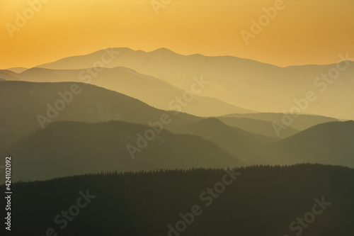 Beautiful sunrise in the Carpathian mountains with fog and dramatic sky 