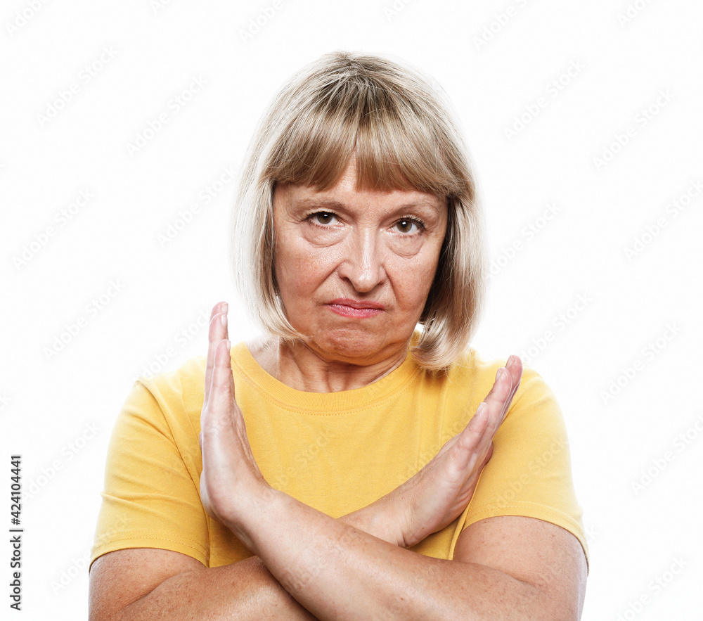 Senior woman with short gray hair wearing casual style rejection expression crossing arms doing negative sign Senior woman with short gray hair wearing casual style rejection expression crossing arms doing negative sign