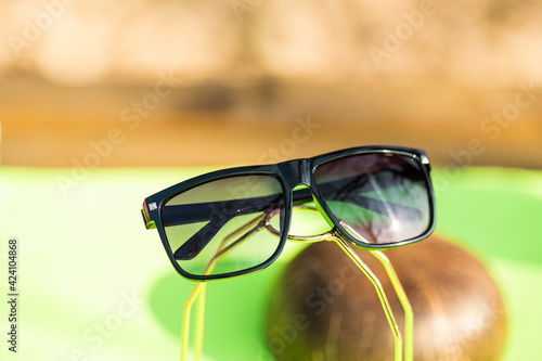 Classic Sunglasses design for men and ladies with black lenses and black frame shoot outside in a summer day closeup. Selective focus. High quality photo