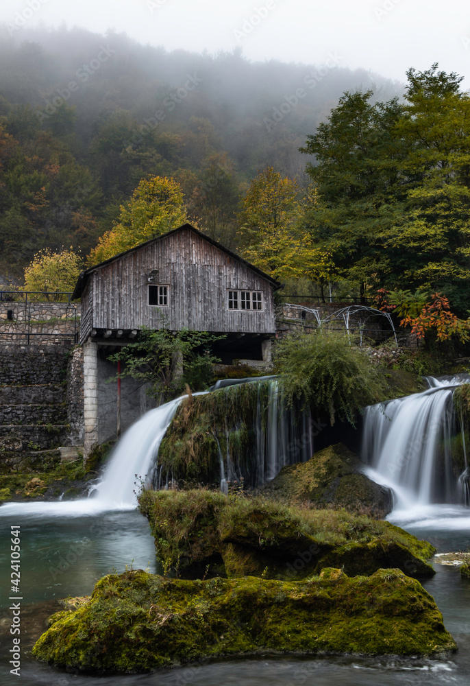 Fototapeta premium waterfall in autumn at old mill