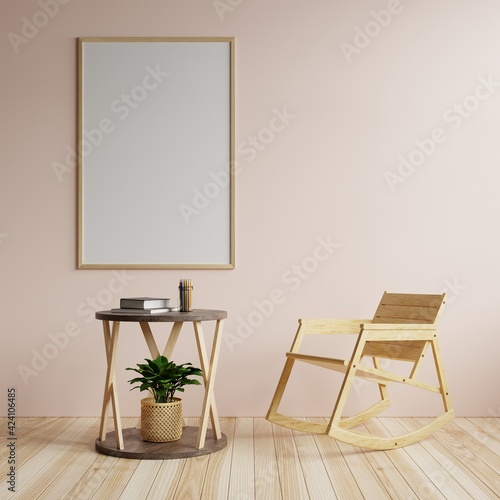 Living room with a large frame on the walls in beautiful pink. Decorated with a tree table and rocking chair on the wooden floor.3d rendering.