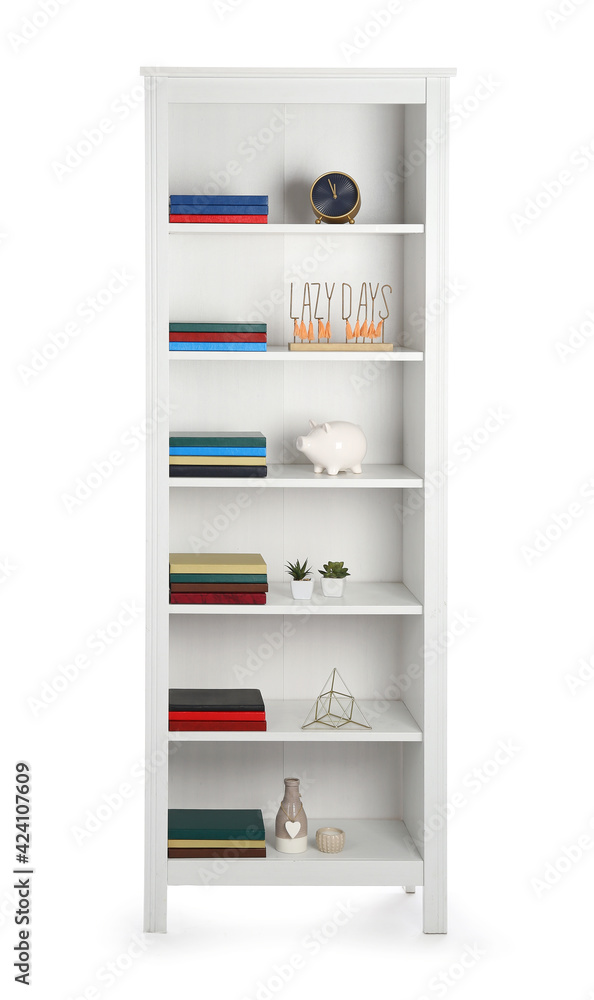 Modern shelf unit with books and decor on white background