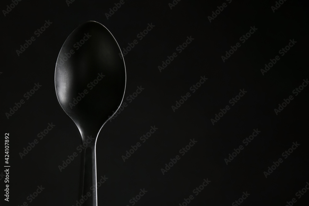 Stylish spoon on dark background Stylish spoon on dark background