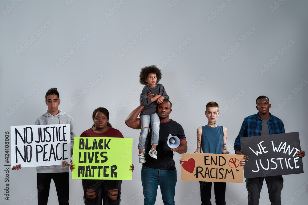 Young multiracial people and kid holding anti racist posters Stock ...
