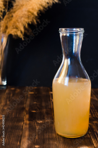 Homemade Kombucha is a fermented  probiotic  organic beverage. Rustic dark wood background  copy space  close-up.