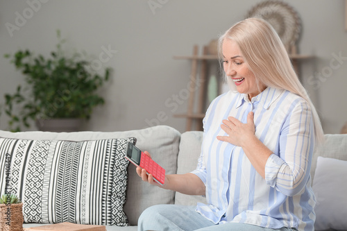 Mature woman with calculato...
