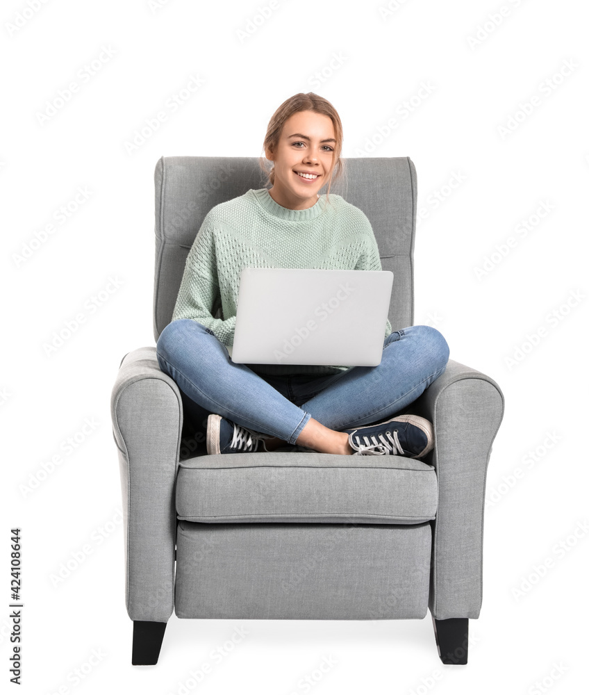 Young woman with laptop sitting in armchair on white background Young woman with laptop sitting in armchair on white background