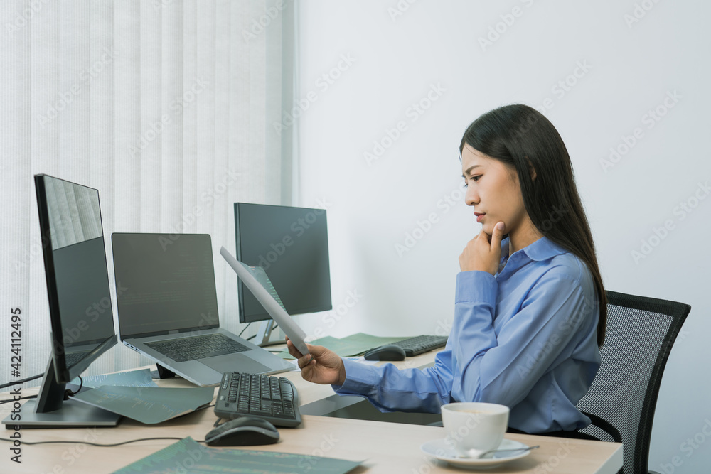 Stress asian woman while coding data programmer on desktop PC while working on computer codes in the office. Stress asian woman while coding data programmer on desktop PC while working on computer codes in the office.