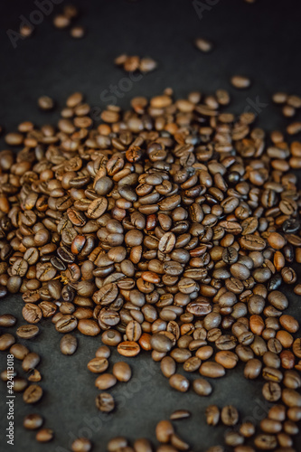 Roasted coffee beans on a black background. Coffee closeup.