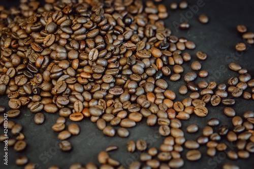 Coffee beans on a black background. Roasted Coffee closeup.