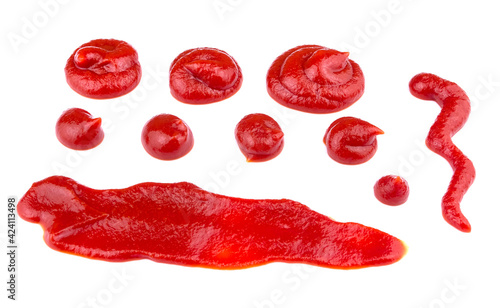Ketchup splashes, group of objects. Arrangement of red ketchup or tomato sauce, isolated white background, top view.