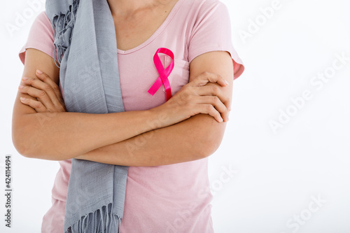 Wallpaper Mural close up of woman in with pink breast cancer awareness ribbon isolated on pink blank copy space studio background,healthcare,medicine concept Torontodigital.ca