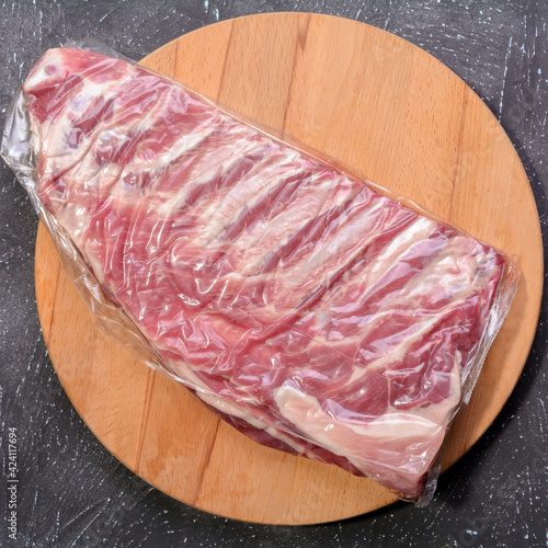 Raw pork ribs. Top the meat ingredient on a slate serving board. close-up.Selective Focus