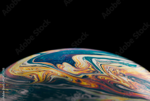 Macro colorful abstract soap bubble on black background