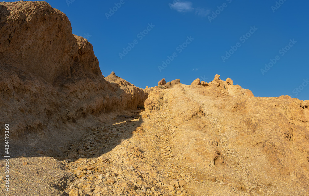 The top of a sandstone mountain against a blue sky