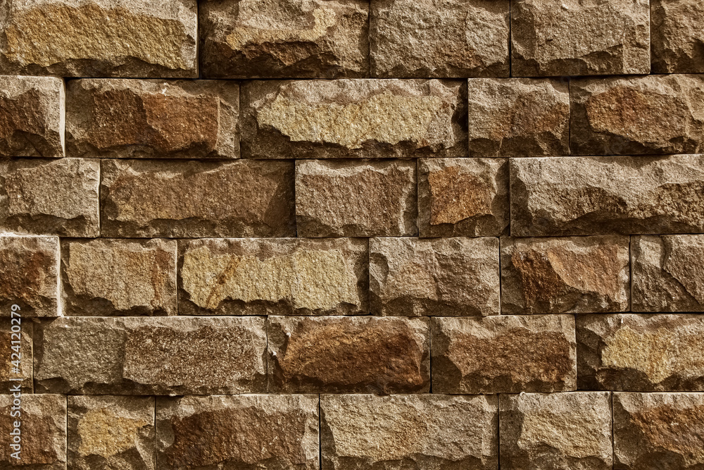 Fototapeta premium Background texture of brown stone wall.