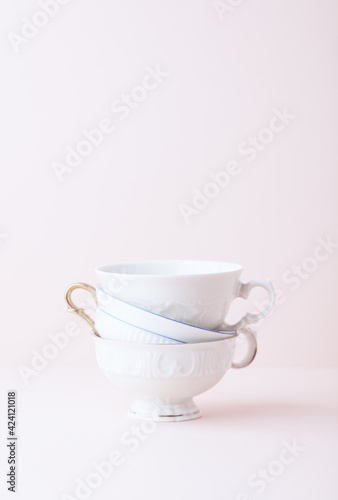 Stack of ceramic cups on bright background. Close up. 
