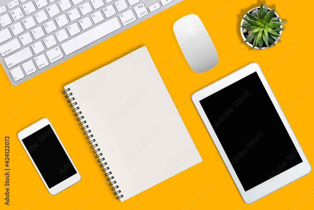 Flat lay photo of office desk with keyboard, notebook, tablet, smartphone and red cup, top view Flat lay photo of office desk with keyboard, notebook, tablet, smartphone and red cup, top view