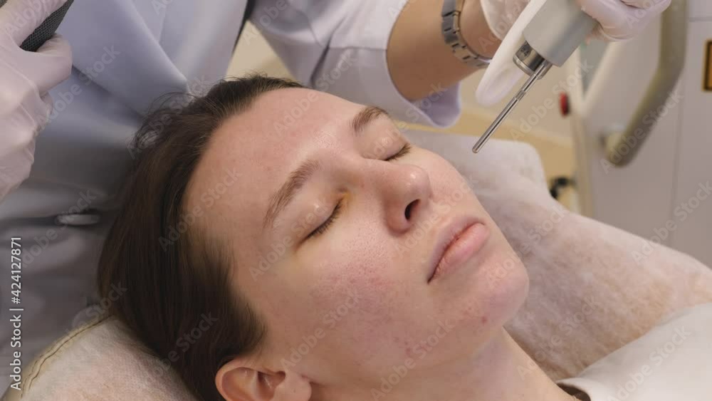 The doctor prepares the patient's face for cosmetic procedures The doctor prepares the patient's face for cosmetic procedures