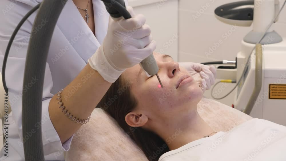 The procedure of rejuvenation of the female face with a laser. Beauty treatments The procedure of rejuvenation of the female face with a laser. Beauty treatments