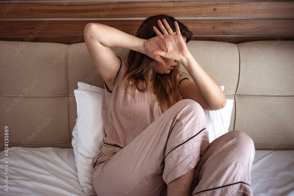 woman protects covers herself with her hands. Young woman defending herself, can be used for domestic violence concept. A woman defends herself against domestic violence woman protects covers herself with her hands. Young woman defending herself, can be used for domestic violence concept. A woman defends herself against domestic violence
