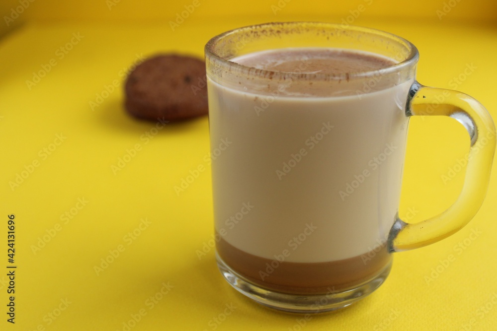 a cup of hot chocolate cocoa on a bright yellow background with room for a copyspace text a cup of hot chocolate cocoa on a bright yellow background with room for a copyspace text