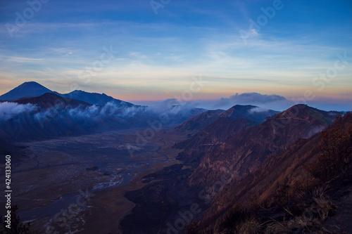 Terrific Bromo Tengger Semeru National Park on East Java, Indonesia. Aerial view of erupting volcano Bromo, Mount Semeru and Mount Batok from Penanjakan view point, observation area to see sunrise. © Blumesser