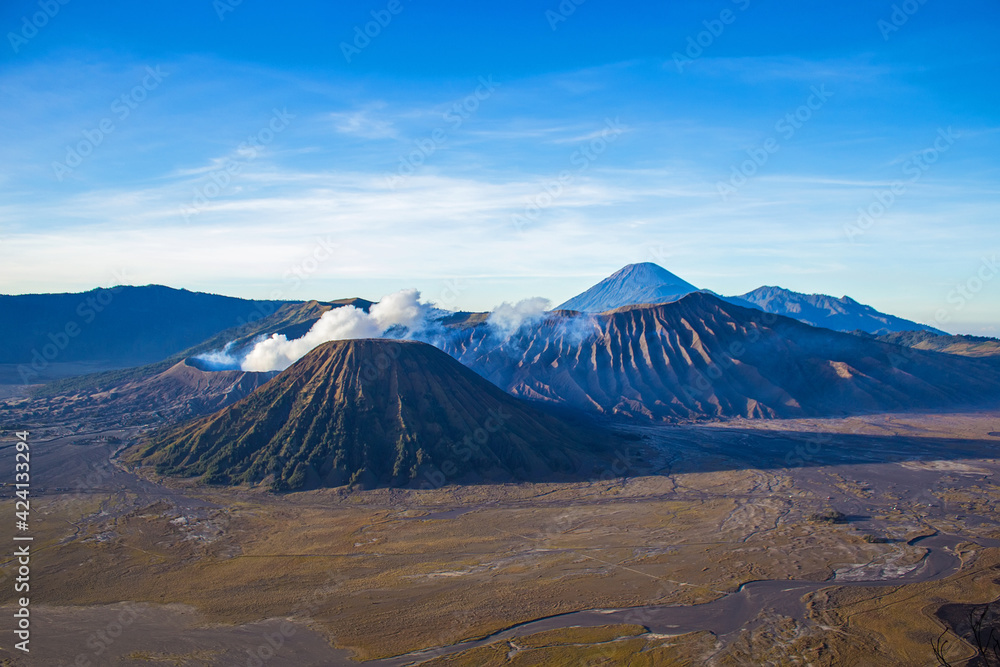 Amazing Bromo Tengger Semeru National Park on East Java, Indonesia. Aerial view of erupting volcano Bromo, Mount Semeru and Mount Batok from Penanjakan view point, observation area to see sunrise.