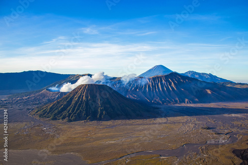 Amazing Bromo Tengger Semeru National Park on East Java, Indonesia. Aerial view of erupting volcano Bromo, Mount Semeru and Mount Batok from Penanjakan view point, observation area to see sunrise.